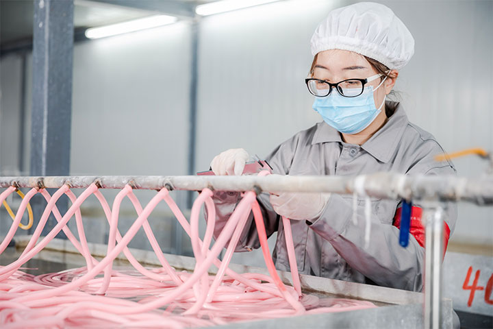 a female worker is measuring the semi-finished products in the manufacturing process