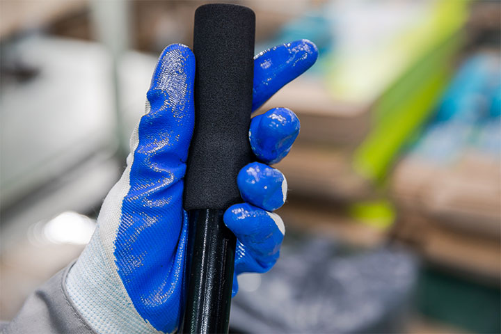 a worker is holding a product and doing visual inspection