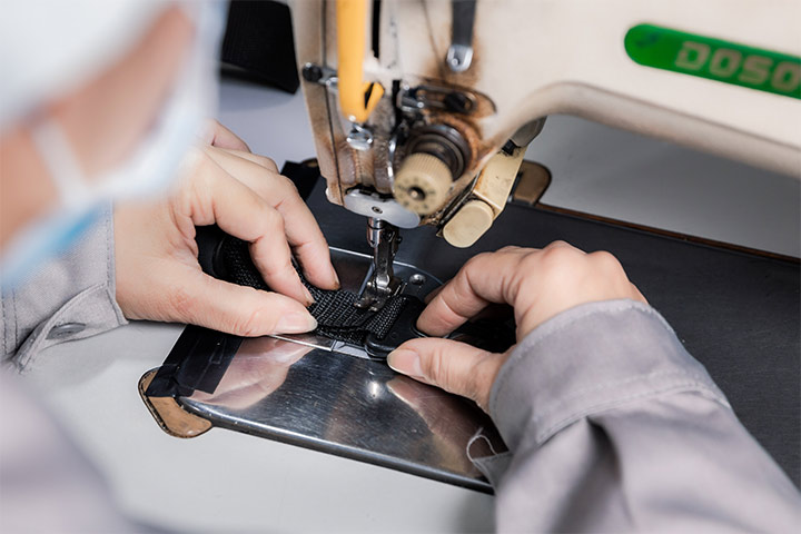 a worker is sewing products