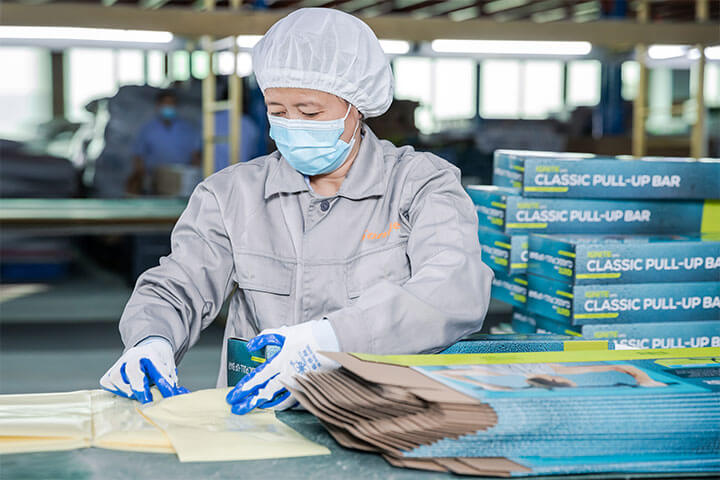 a female worker is checking the quality of product packaging